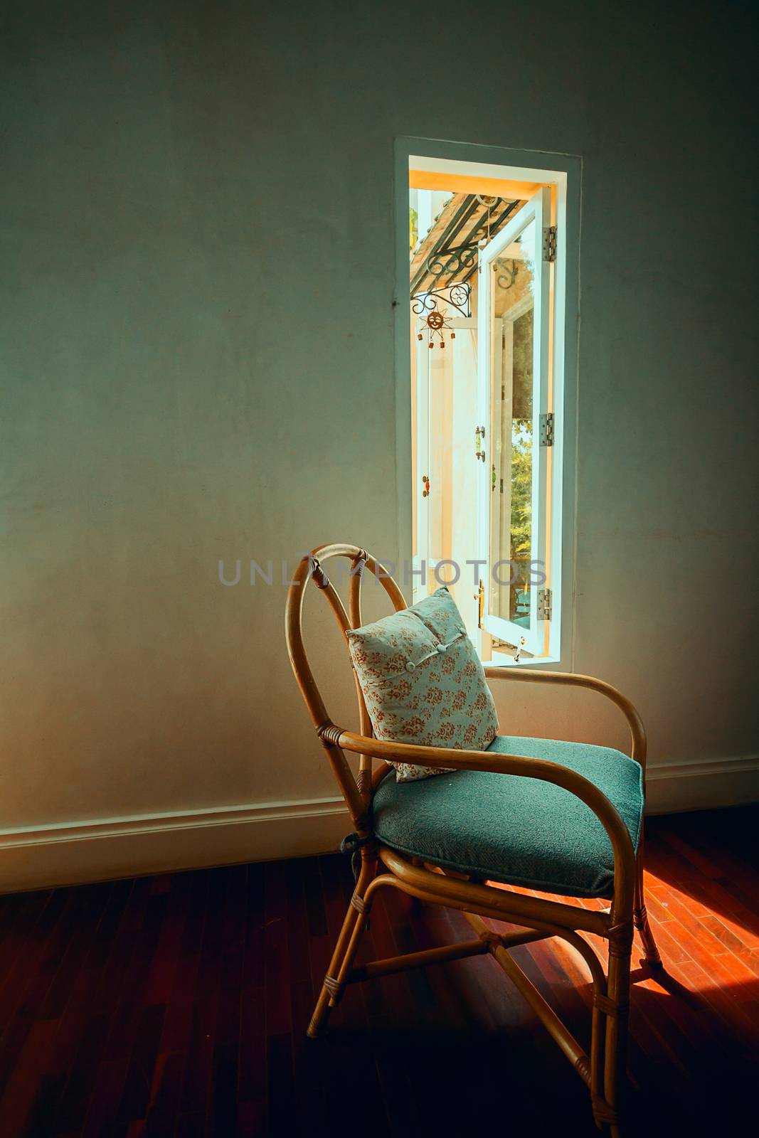 relaxing on free time day at home. vintage chair near window with warm light for relax on weekend or holiday