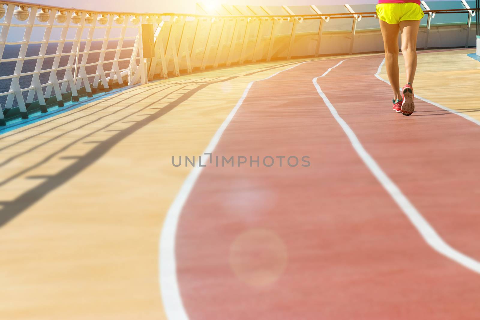 healthy vacation lifestyle. young fitness woman run on athlete running track at cruising boat. sport background