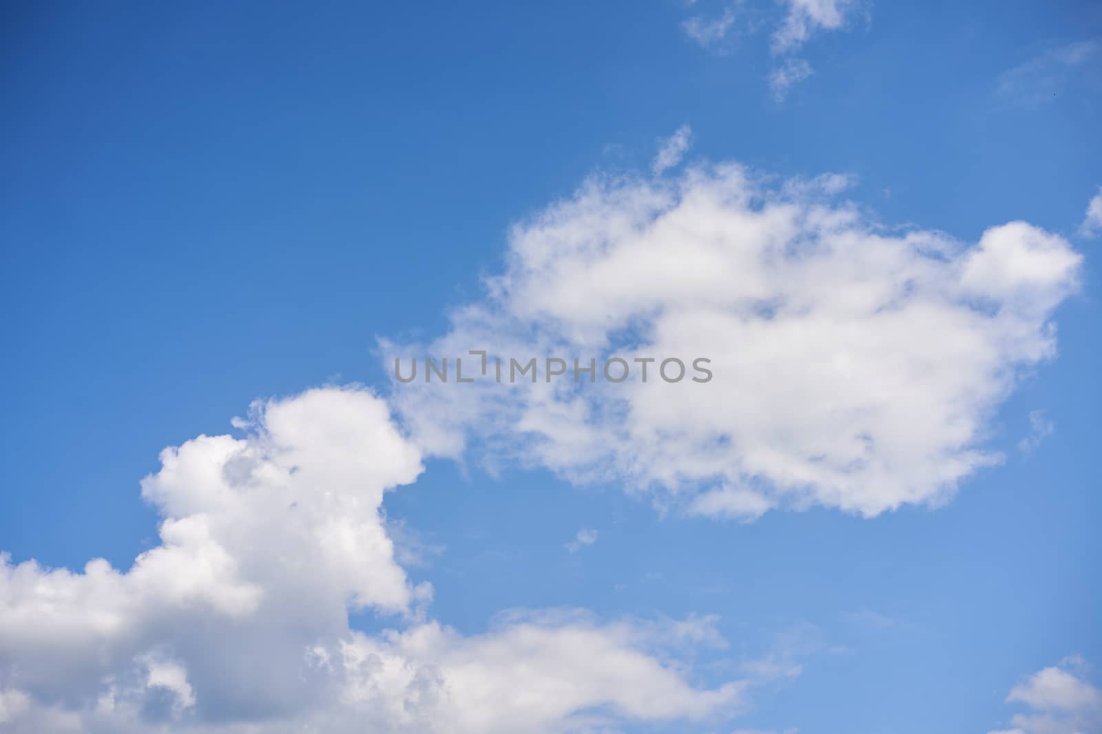 Blue sky with white fluffy cloud summer sunny day background
