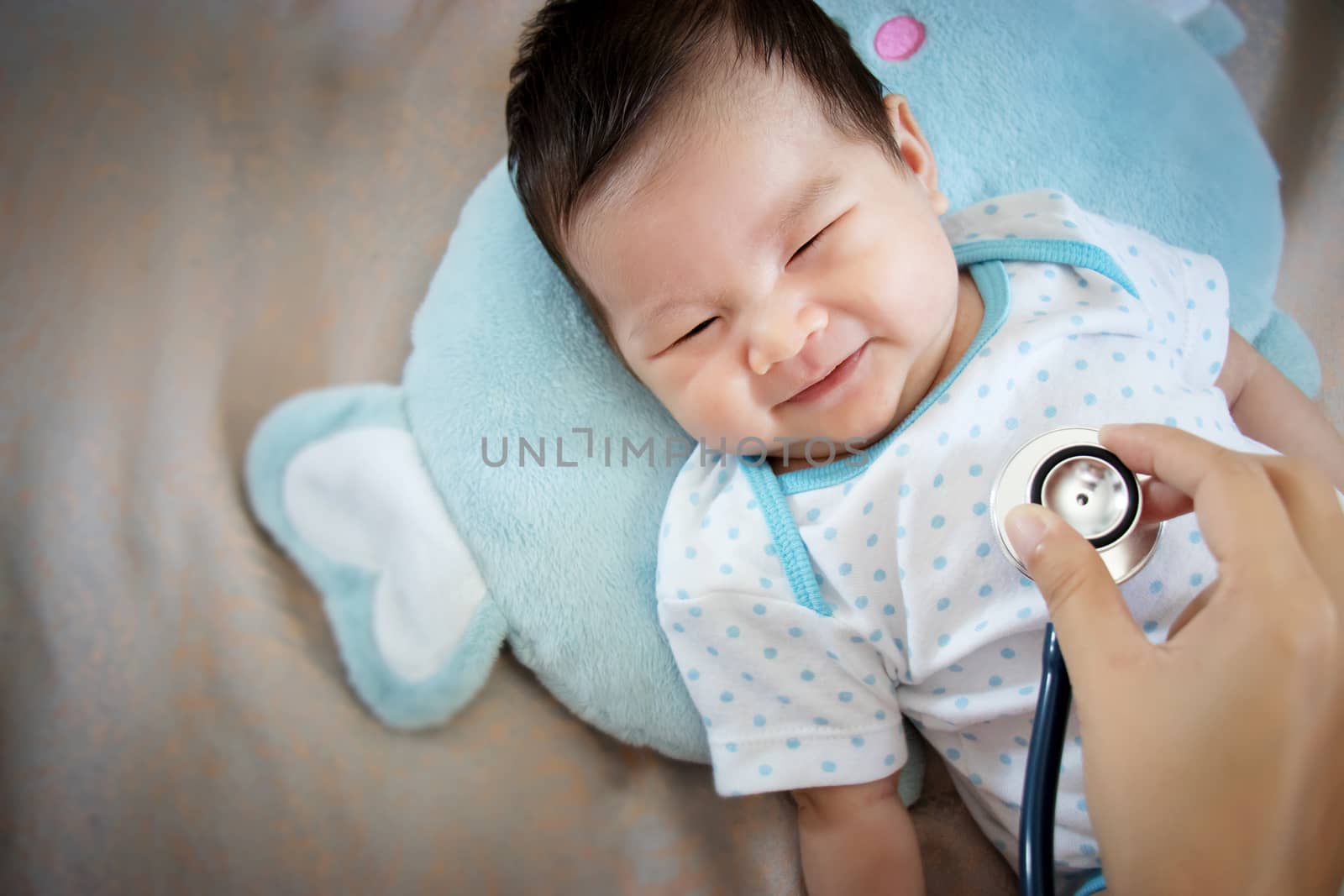 healthy people concept. Asian adorable baby infant laughing with happy face for good health on doctor check up time by asiandelight