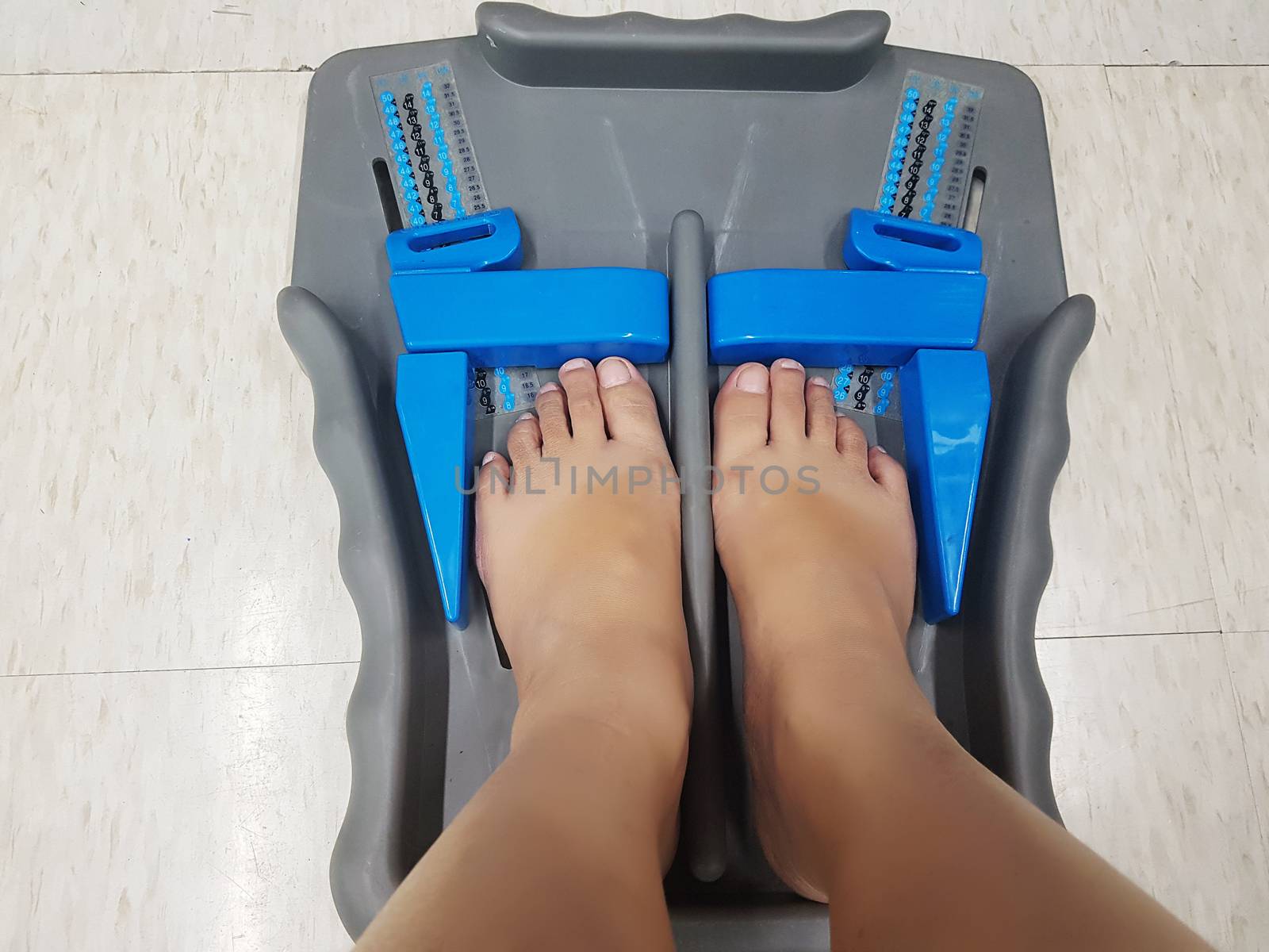 Foot measure tool - feet of customer in measure shoe size in retail footwear stores to measure accurately foot sizes on the floor. Made of plastic with simple functional.