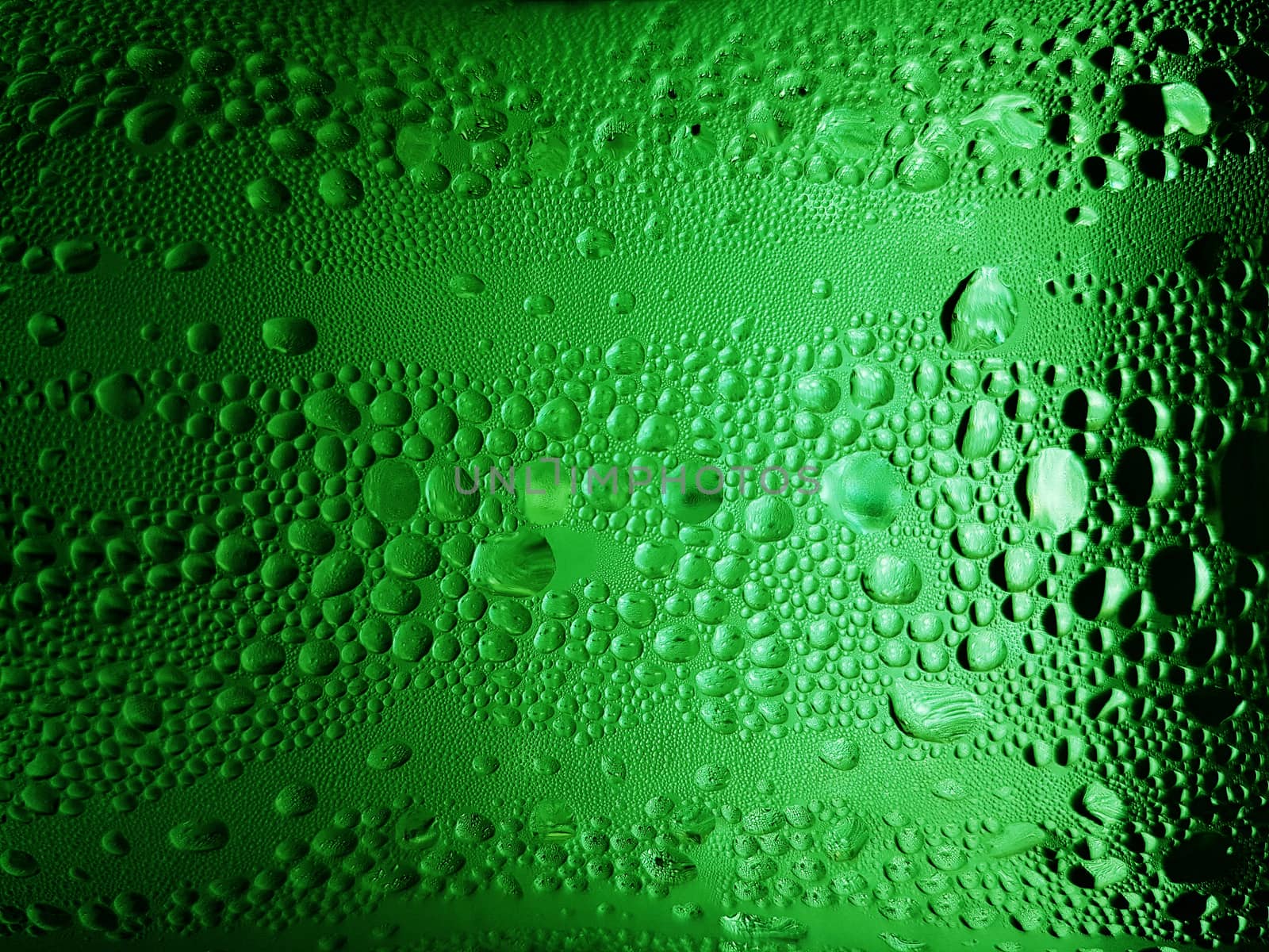 abstract background : bubble of sparkling water soda on the green glass bottle with gradient light