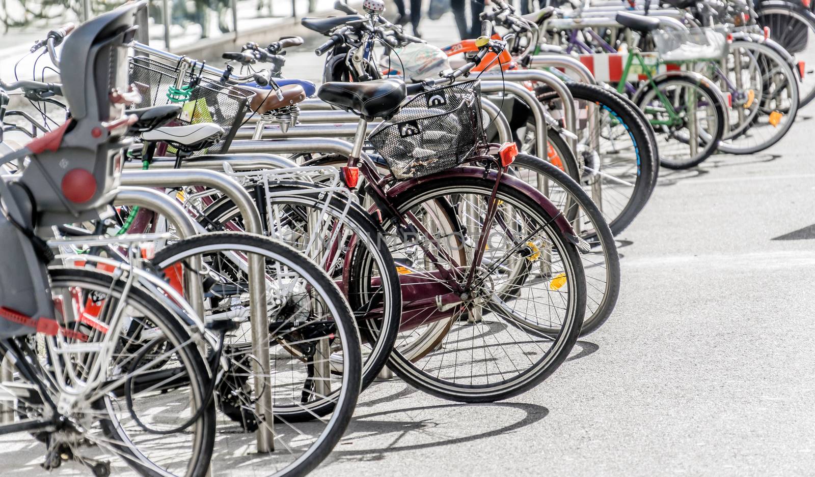 Bicycle rack in a pedestrian zone with many parked bicycles