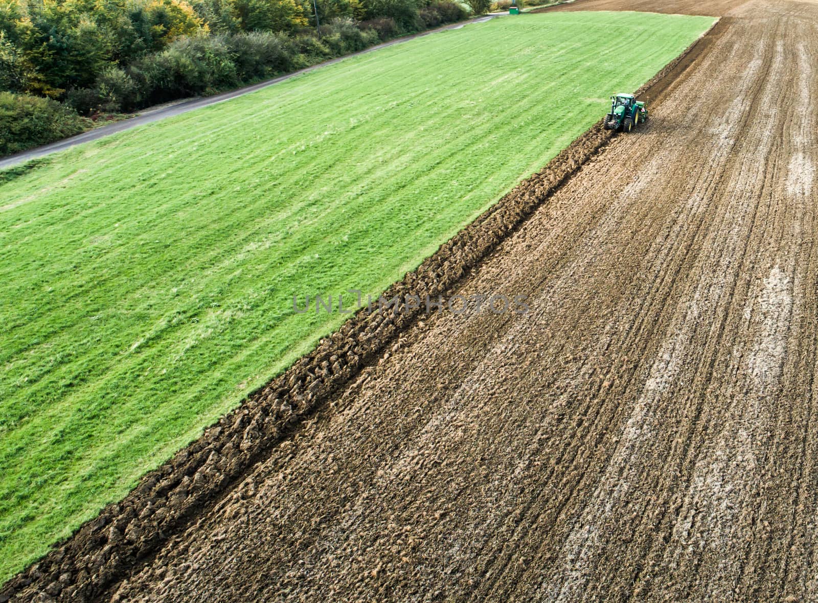 Farmer ploughing a field, aerial view from a flight altitude of about 60 meters