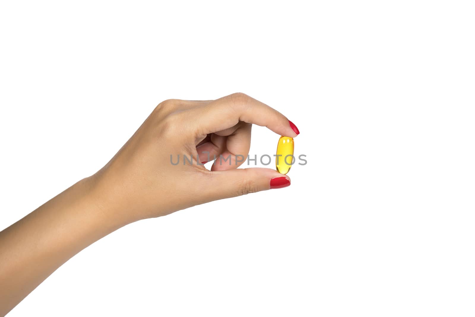 Vitamin, supplement for healthy concept. Closeup of woman hand holding yellow fish oil pill isolated on white background. Healthy eating diet nutrition. High resolution image with space for your text. by asiandelight