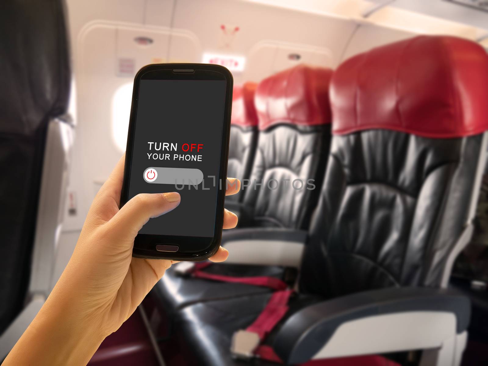 In-flight Security concept. Passenger turn off portable electronic devices and mobile phone or use flight mode on airplane aboard airliners between flight service by asiandelight