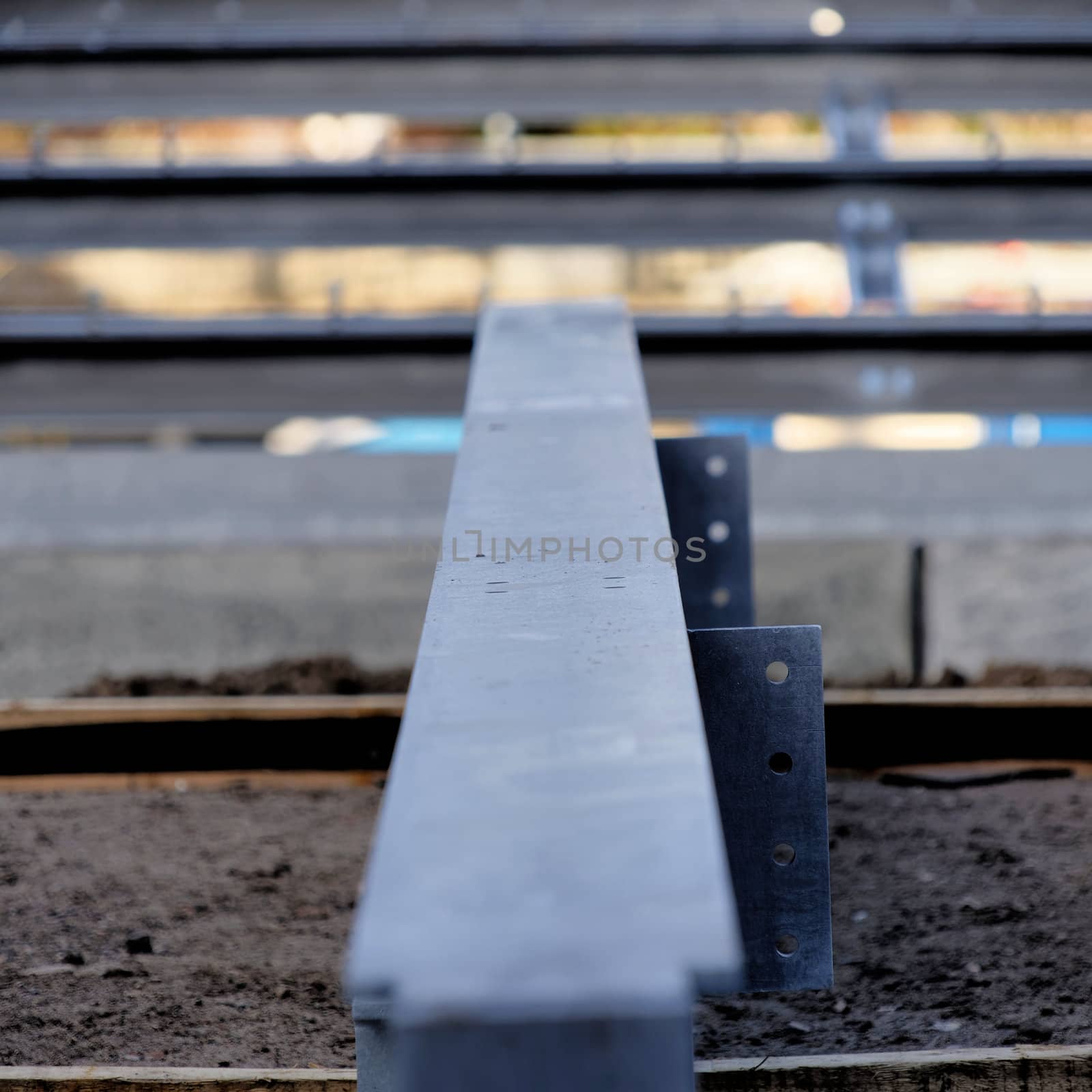 Steel girder on a construction site, with low depth of field directly from the front, central perspective, abstract