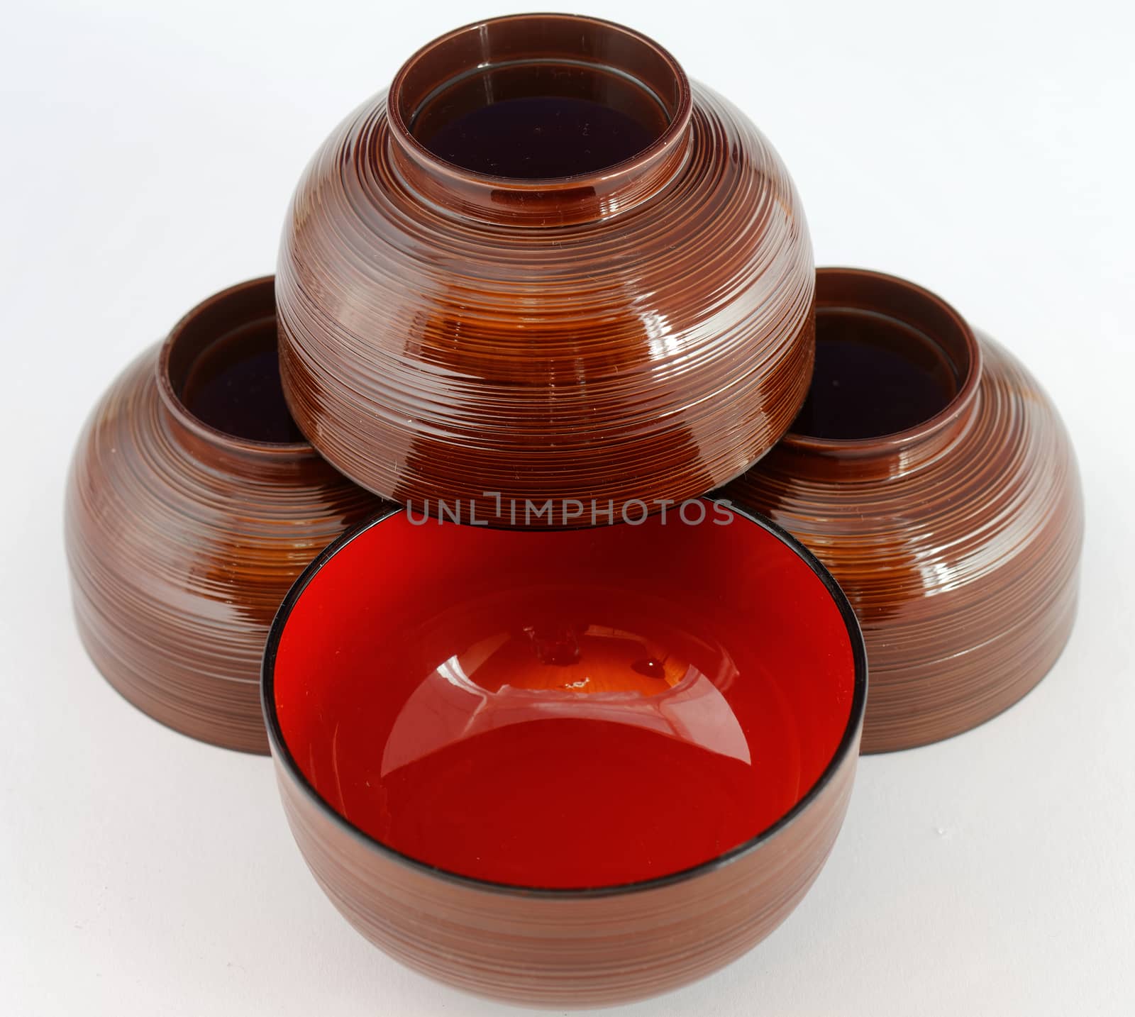 Still life of four Japanese lacquer bowls for miso soup or noodle soup, isolated