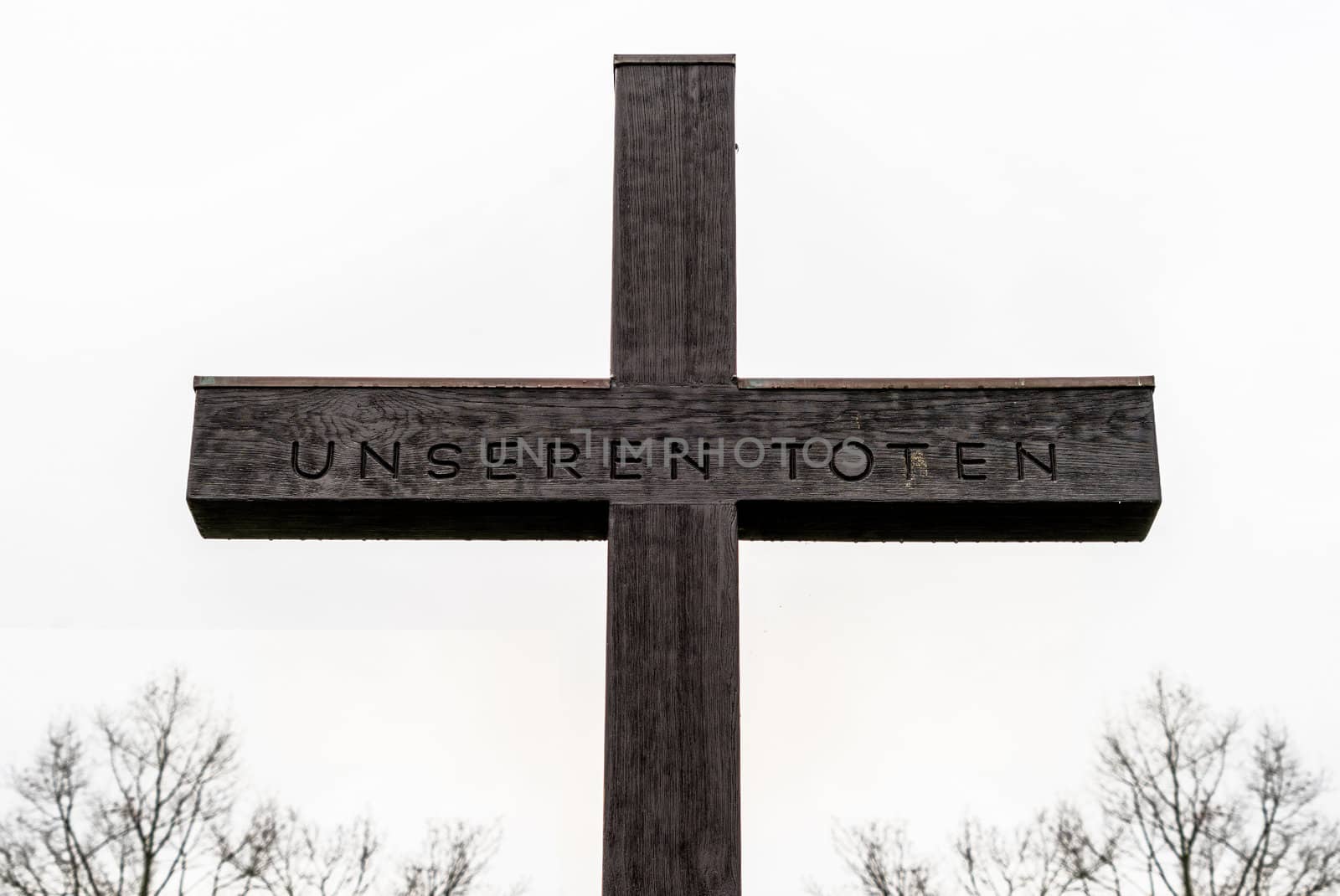 Cross with the inscription "For our dead", behind the castle of Fallersleben, Germany