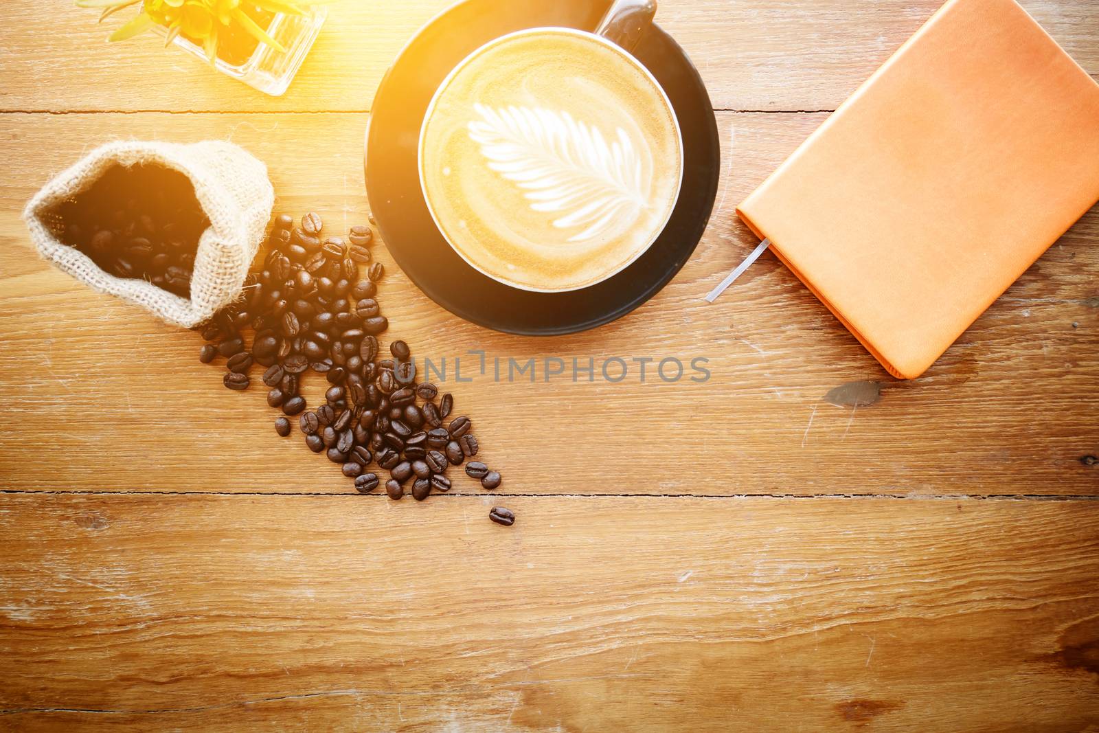 Office table with cup of coffee and coffee bean. Empty place for text. film effect by asiandelight