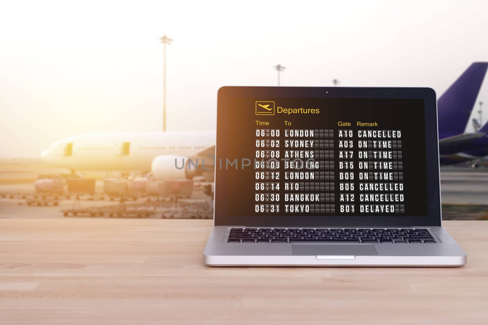 Technology for comfortable travel, tourist, traveler concept : Flight status on notebook , laptop with airport and blur airplane background , film effect. Check in online. Check flight status online. by asiandelight