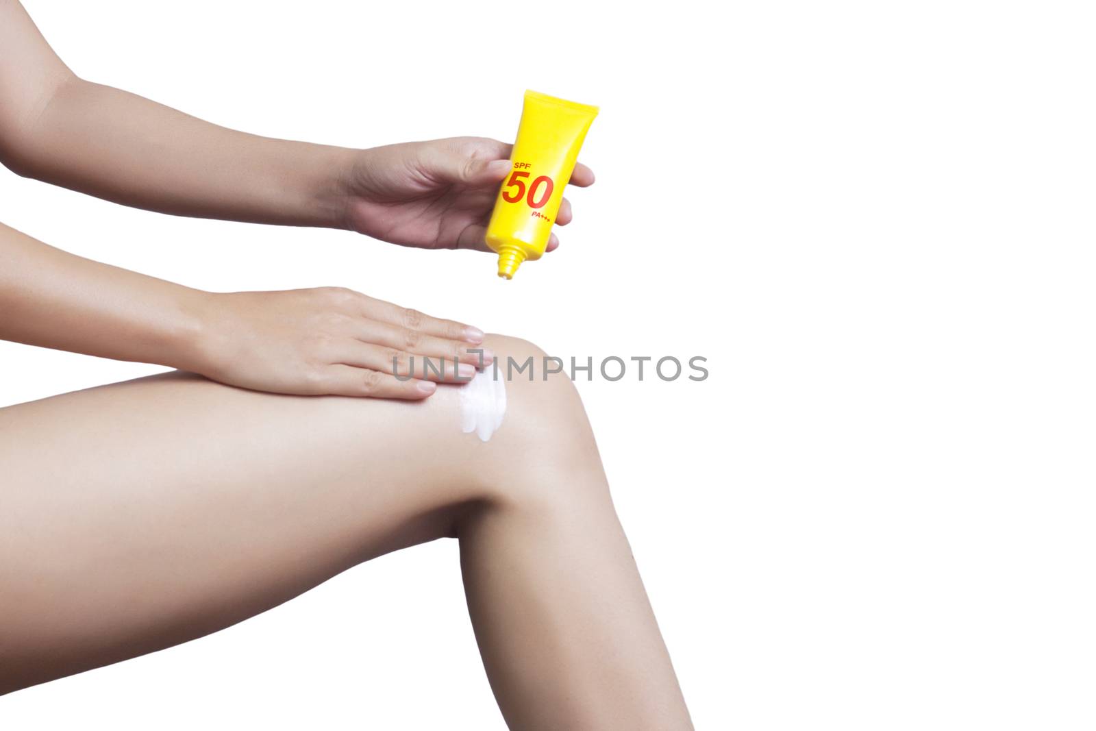 Woman applying sunscreen on her leg isolate on white background , clipping path include. SPF sunblock protection concept. Travel vacation