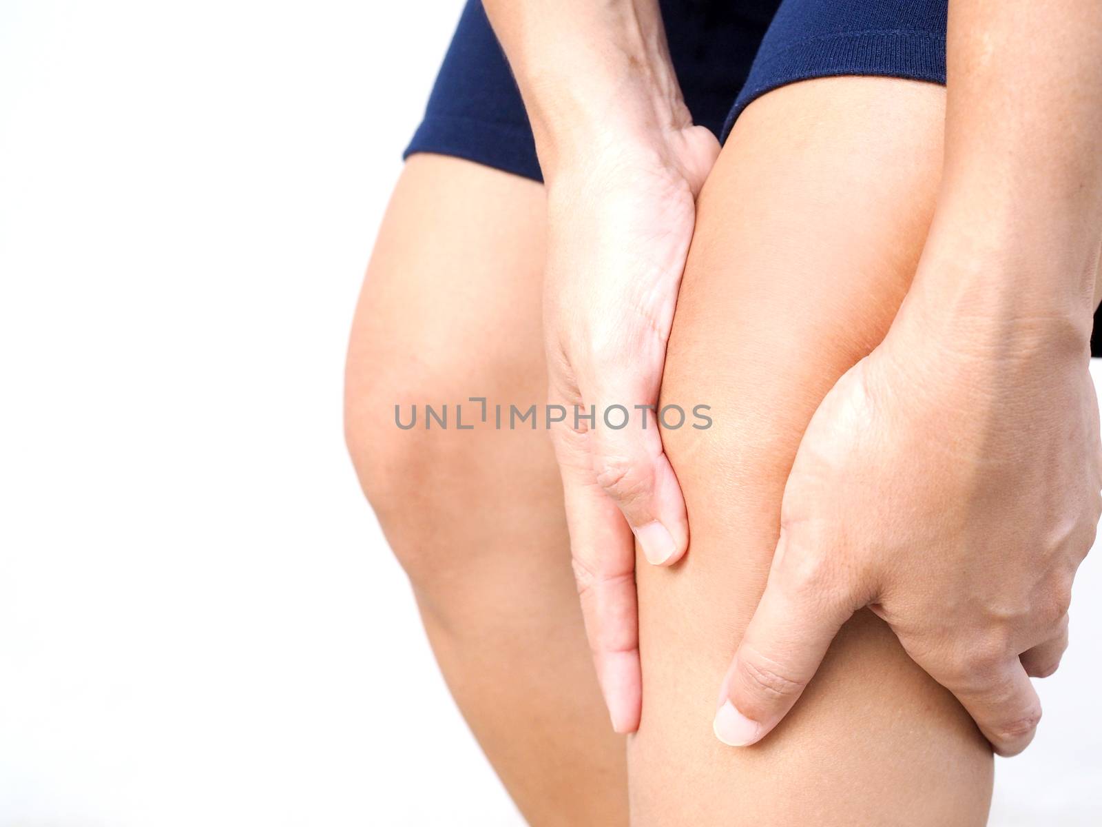 Close-up of Thai Asian body with leg ache and knee pain, isolated on white background.