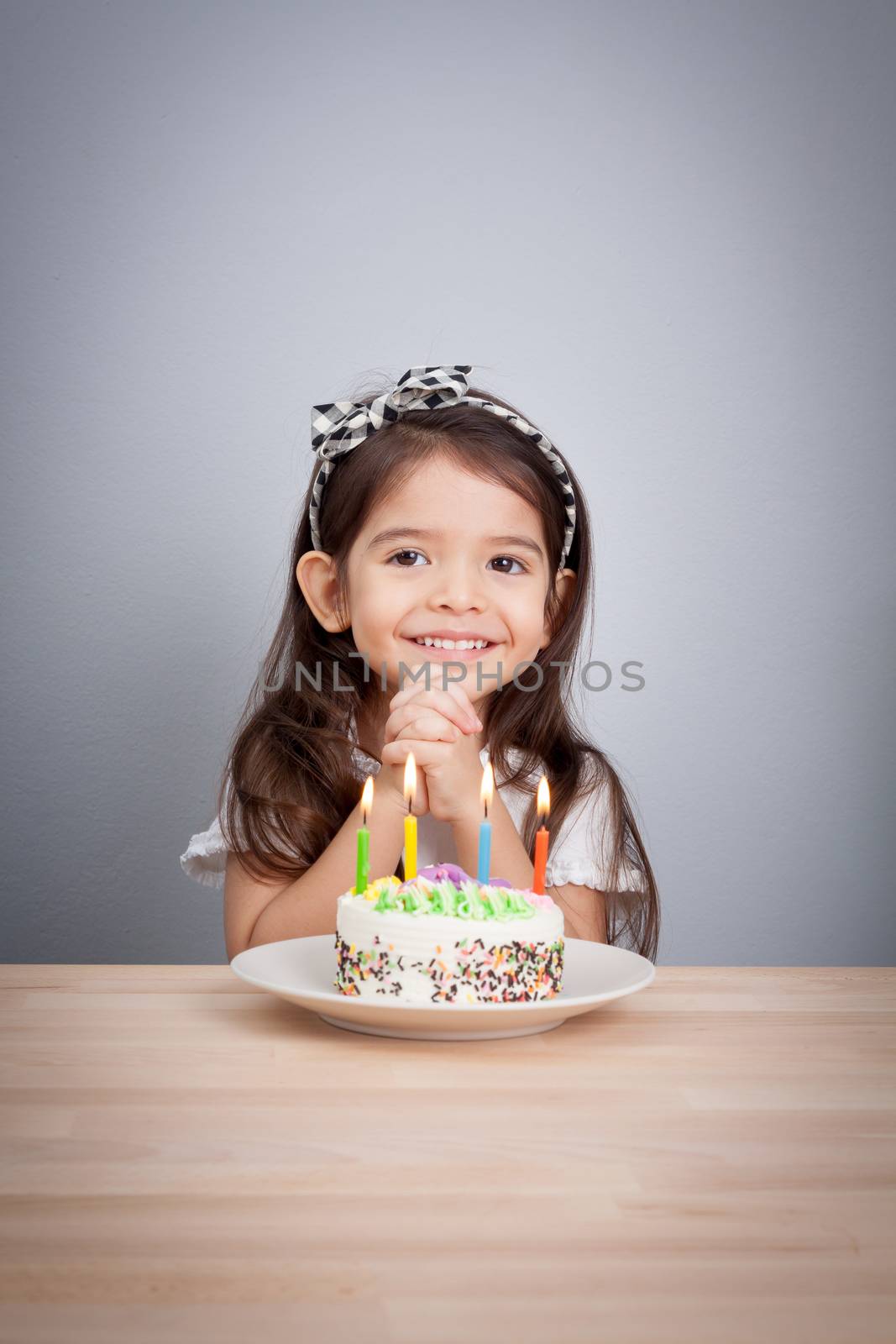 cute girl make a wish on birthday. Happy Birthday background. Greeting background for card, flyer, poster, sign, banner, web, postcard, invitation. Abstract background for text, type, quote