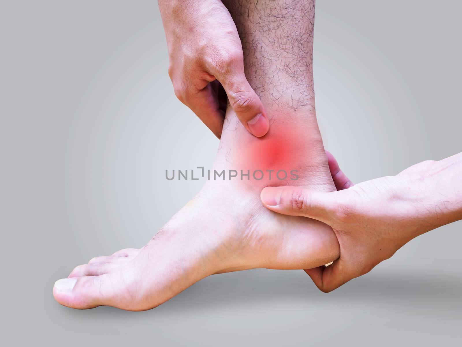 Young man suffering foot and ankle pain or sprained ankle.