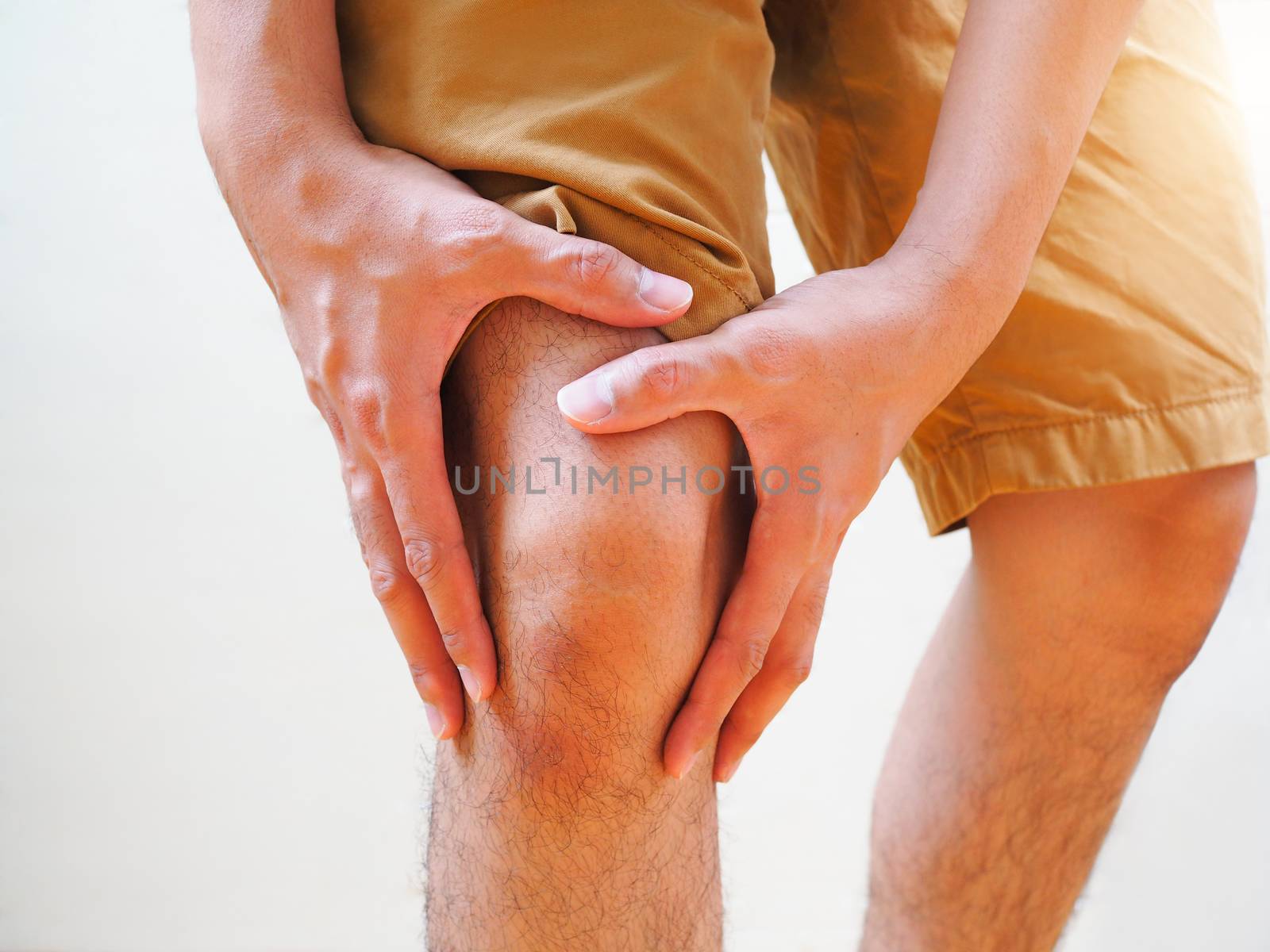 Young man suffering osteoarthritis knee pain, Body and leg pain from gout.