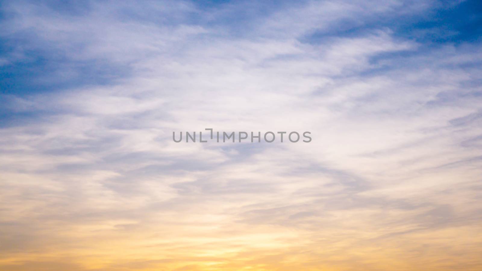 Abstract background with evening sky at sunset with gradient color yellow and blue.