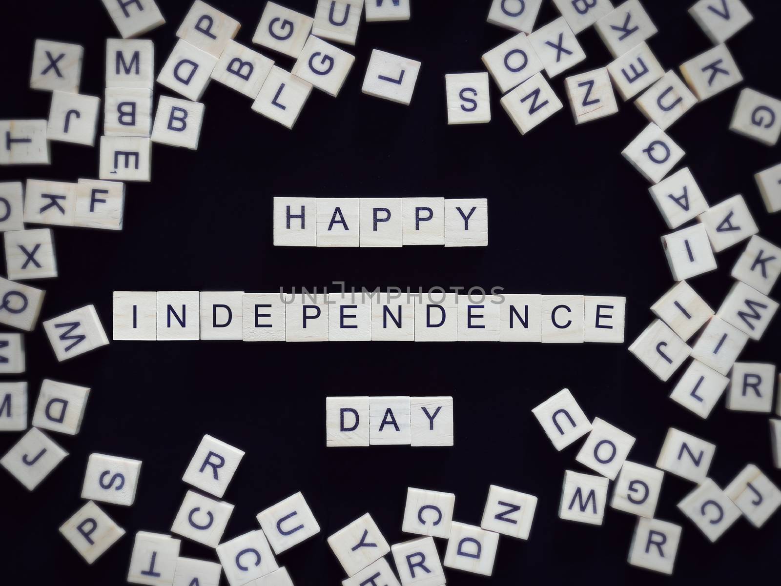 Happy Independence Day greeting card, alphabet letters word happy independence day on wooden pieces, isolated on black for background by asiandelight