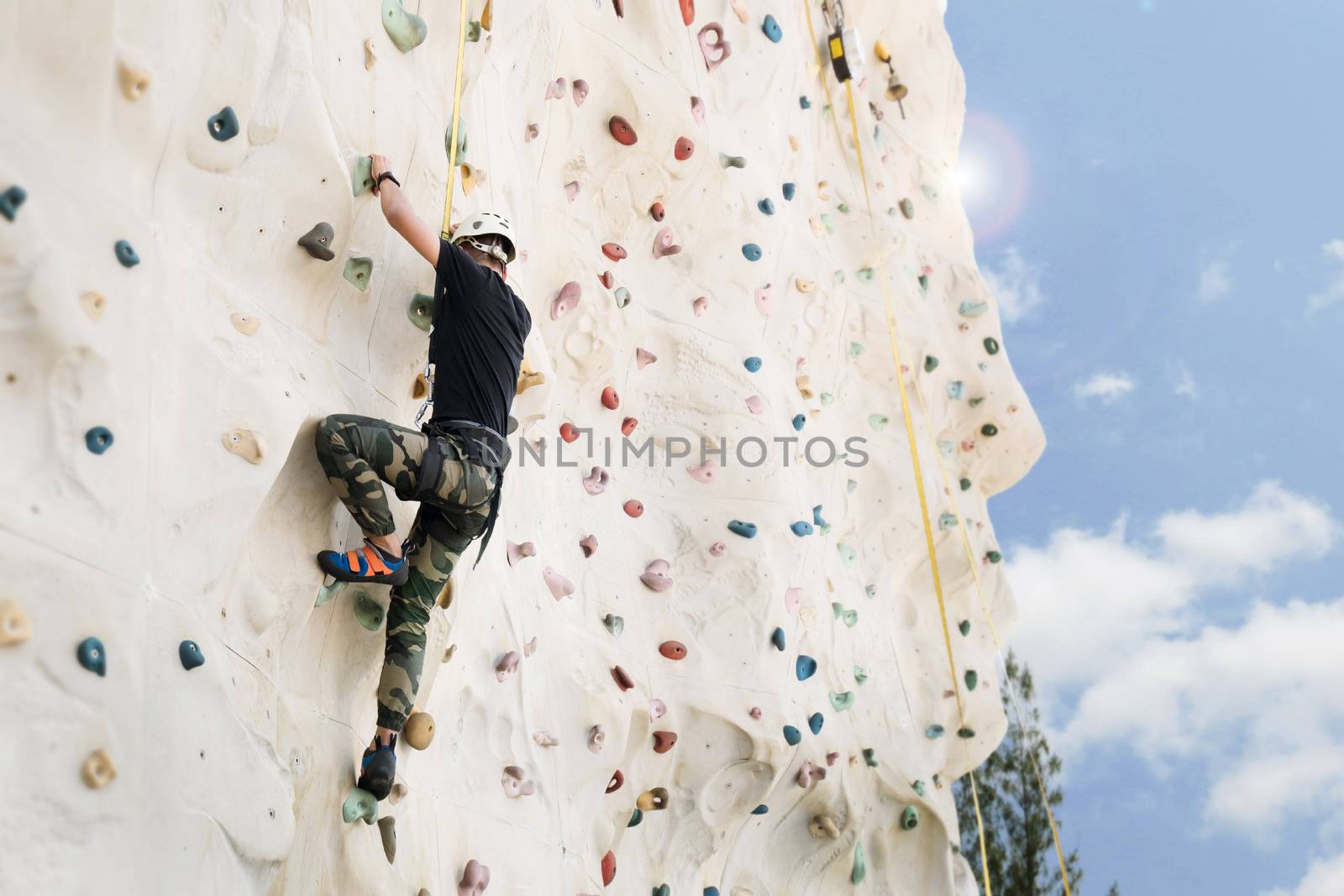 Outdoor climbing sport activity concept : Man climber on artificial climbing wall