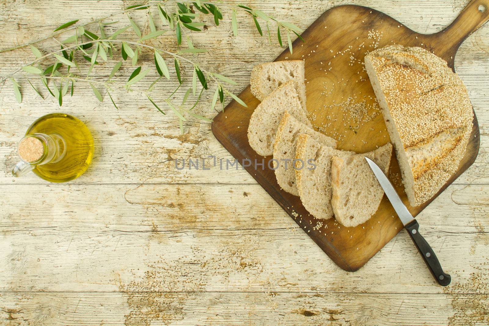 Close-up of a sliced loaf of homemade bread with sesame seeds, a by robbyfontanesi