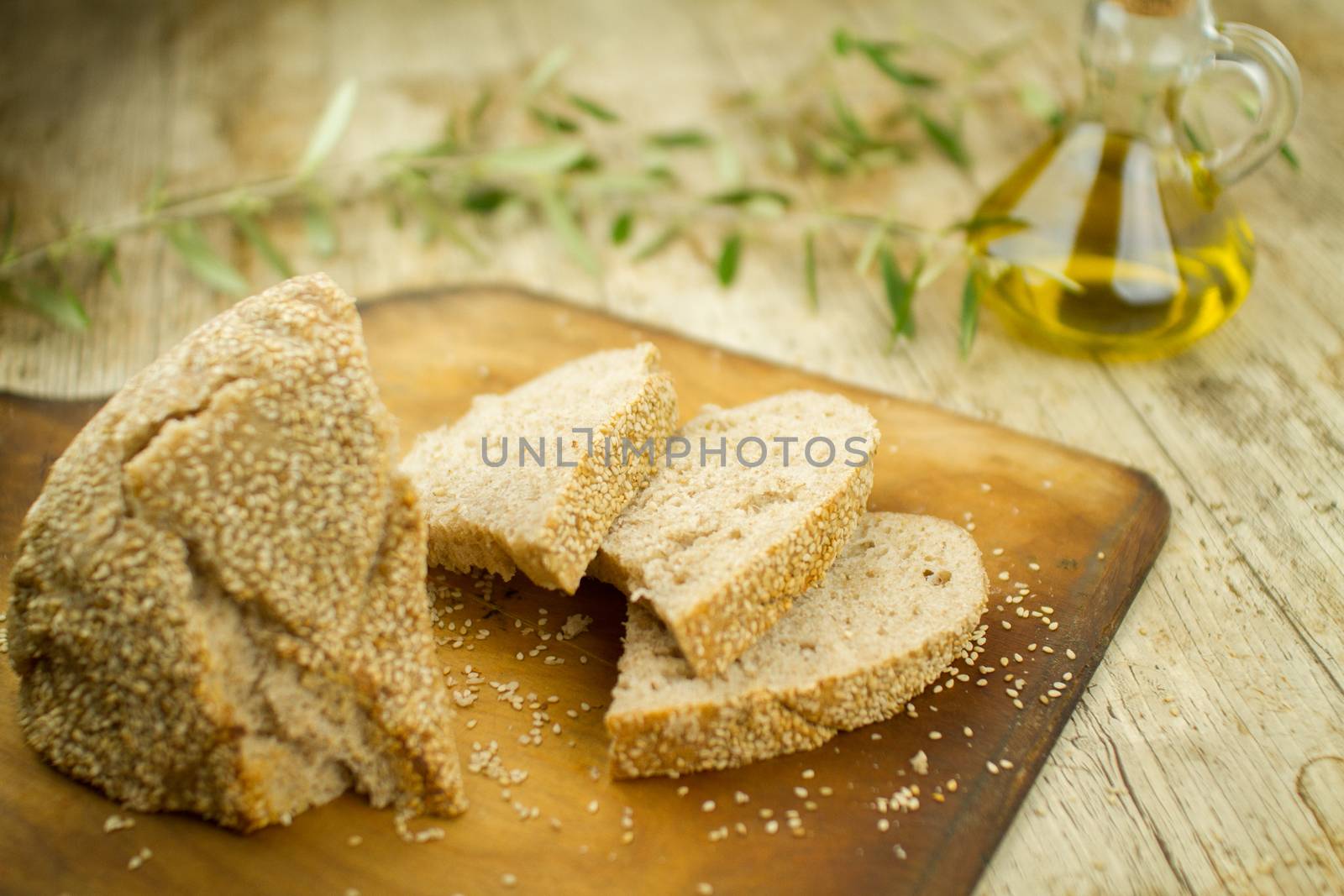 Close-up of a sliced loaf of homemade bread with sesame seeds, a by robbyfontanesi