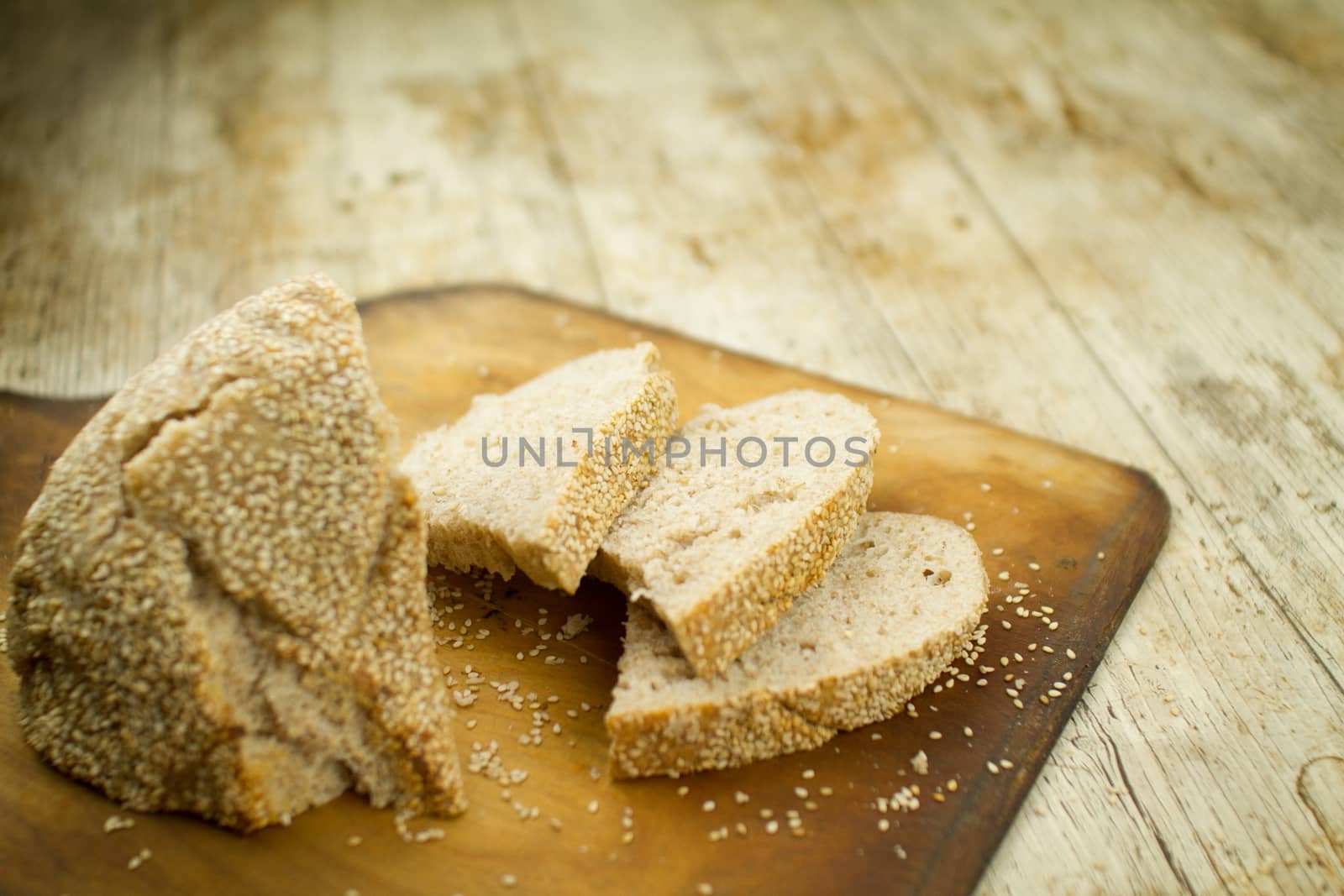 Close-up of a sliced loaf of homemade bread with sesame seeds i