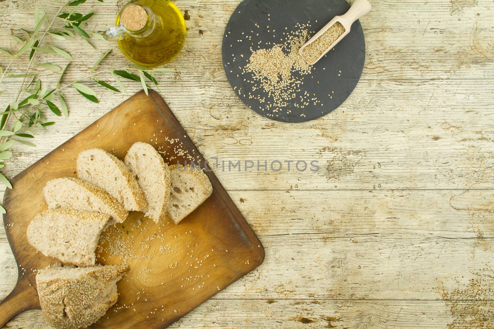 Close-up of a sliced loaf of homemade bread with sesame seeds, a by robbyfontanesi