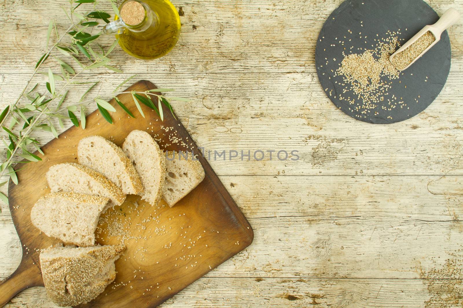 Close-up of a sliced loaf of homemade bread with sesame seeds, a