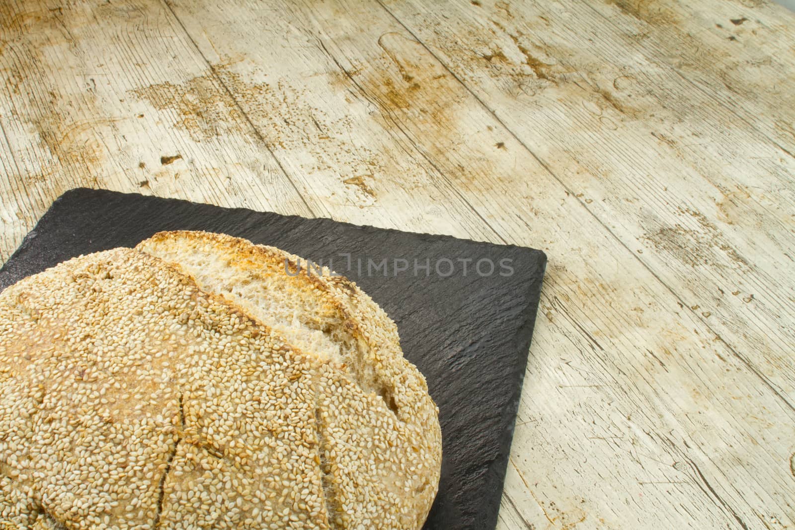 Close-up of a loaf of homemade bread with sesame seeds in select by robbyfontanesi