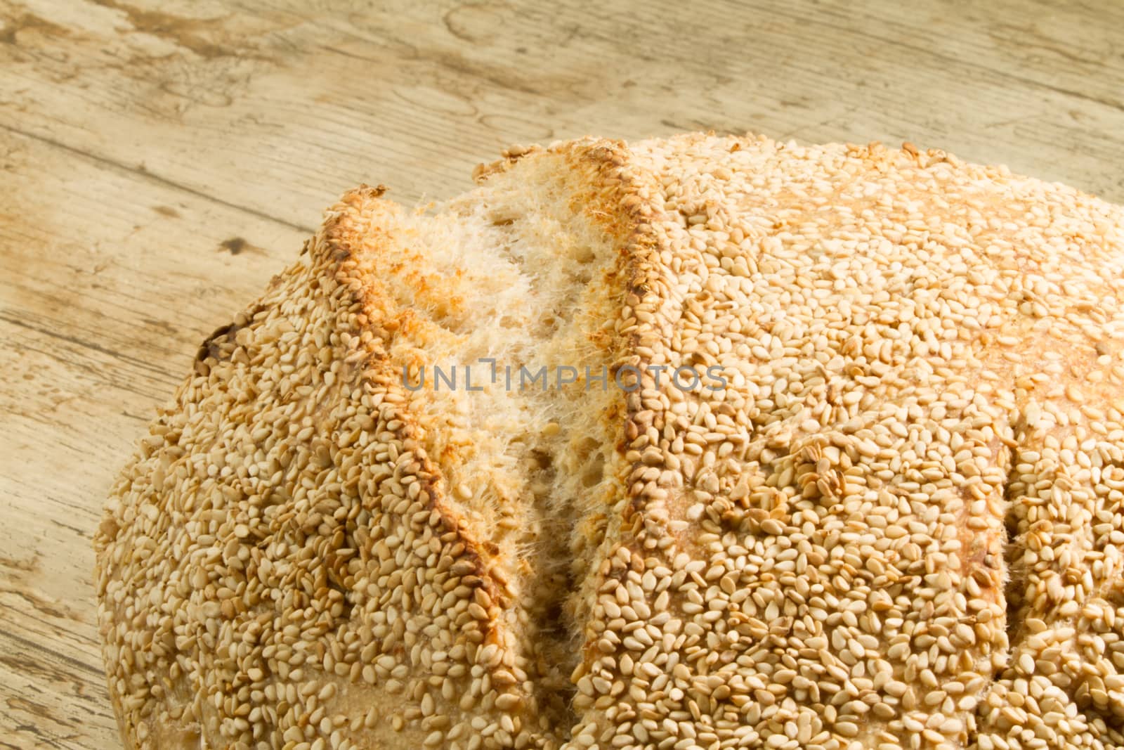 Closeup of a loaf of homemade bread with sesame seeds in selecti