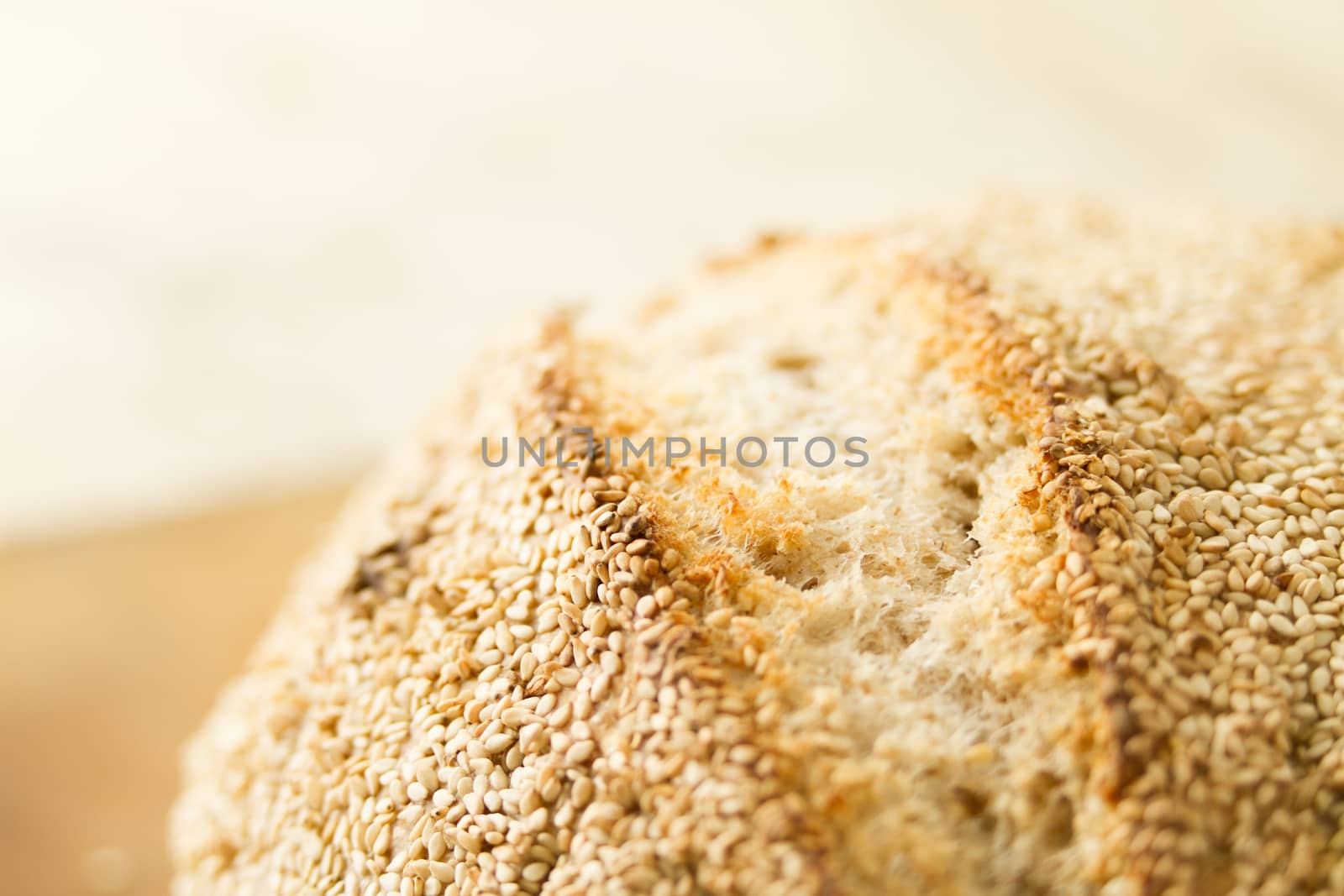 Closeup of a loaf of homemade bread with sesame seeds in selecti by robbyfontanesi
