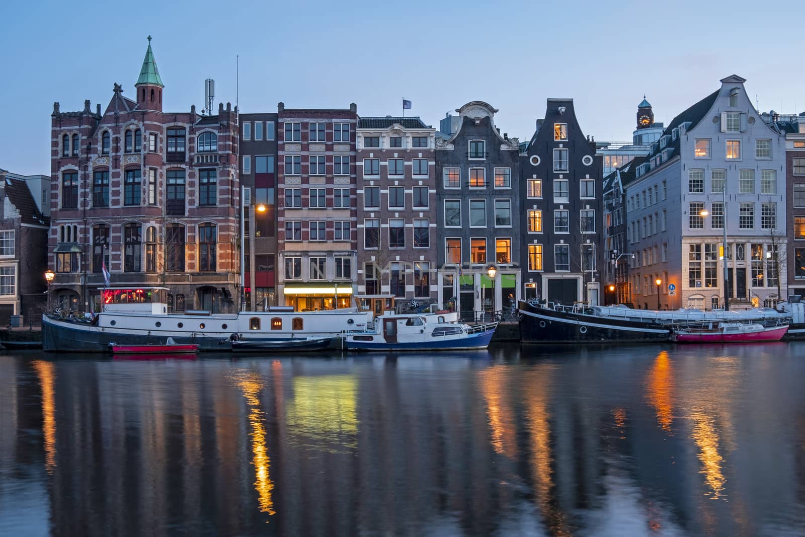 Amsterdam houses and house boats along the Amstel in Amsterdam the Netherlands at sunset