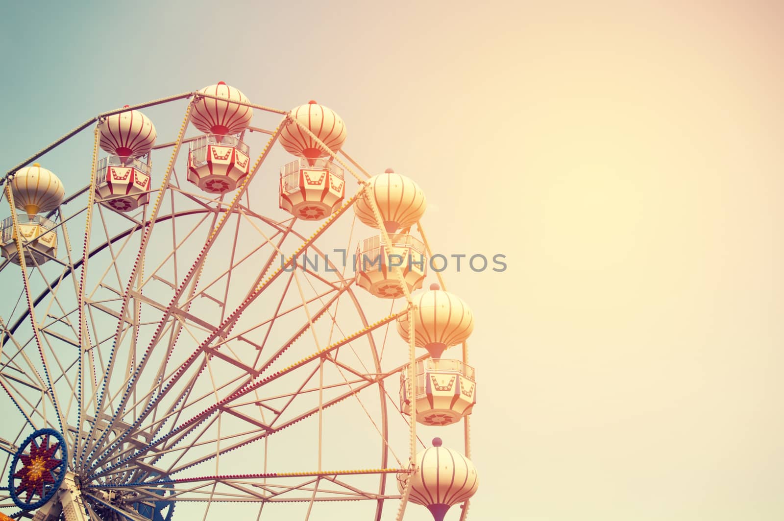 Ferris wheel on sky background with sunlight by Nu1983