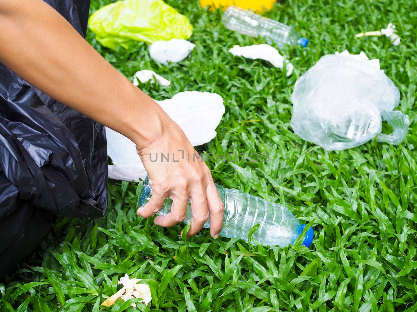 Volunteer spirit with conserving and preserving environment by garbage collection Plastic water bottle with black bag Dumped in yellow trash To recycle.