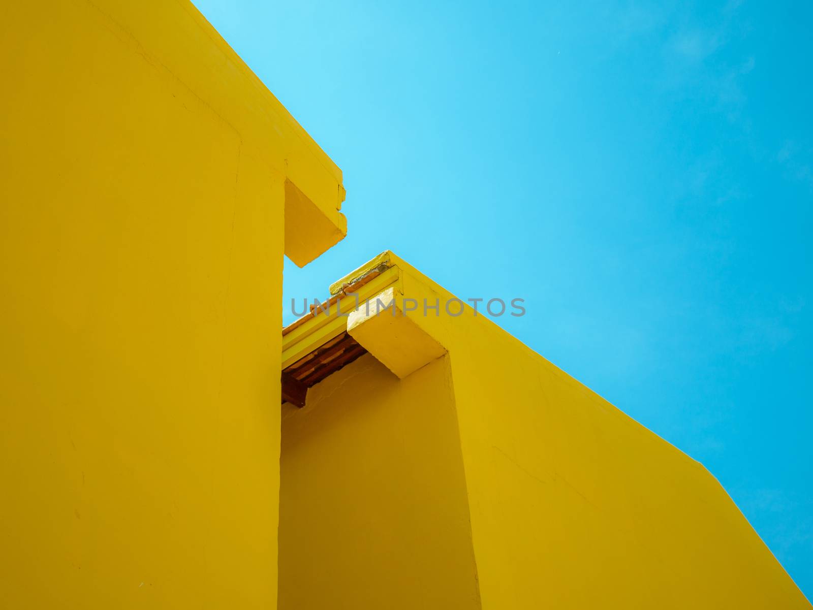 Two yellow building with clear blue sky for abstract background by asiandelight