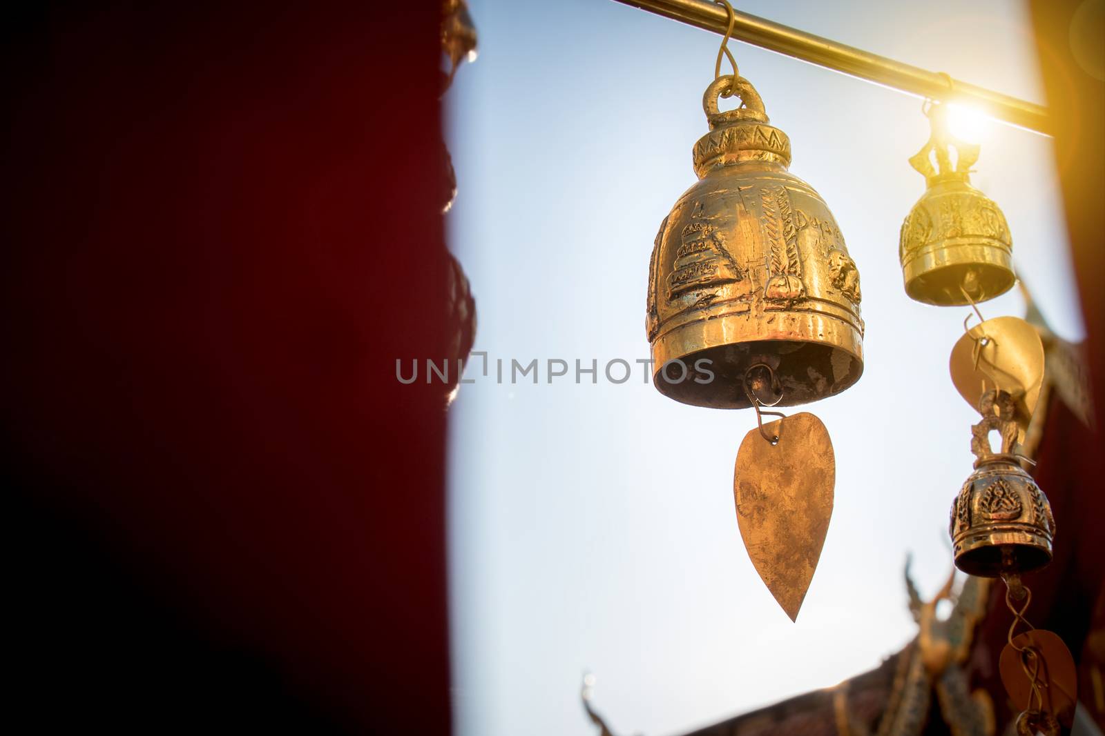 Small bell for pray decorate around Thai buddha temple with sunrise at Doi suthep landmark  for tourist in Chiang Mai province , Thailand