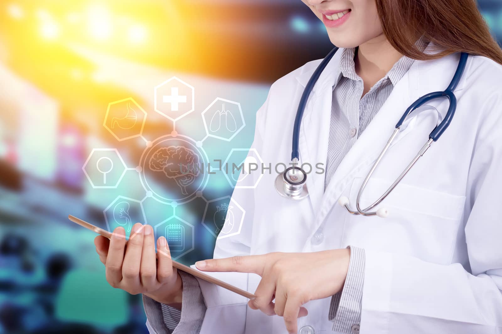 Healthy technology concept : Young Asian woman doctor using technology on tablet for patient chart with hologram graphic chart popup from tablet on doctor hand for patient consultants,  anonymous face