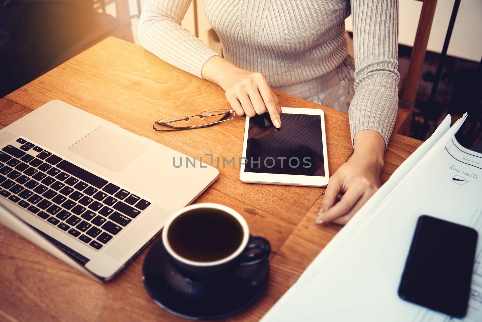 Asian architect woman working at home with tablet and blueprints, engineer inspection in workplace for architectural plan,sketching a construction project. Beautiful Asia female model in her 20s.