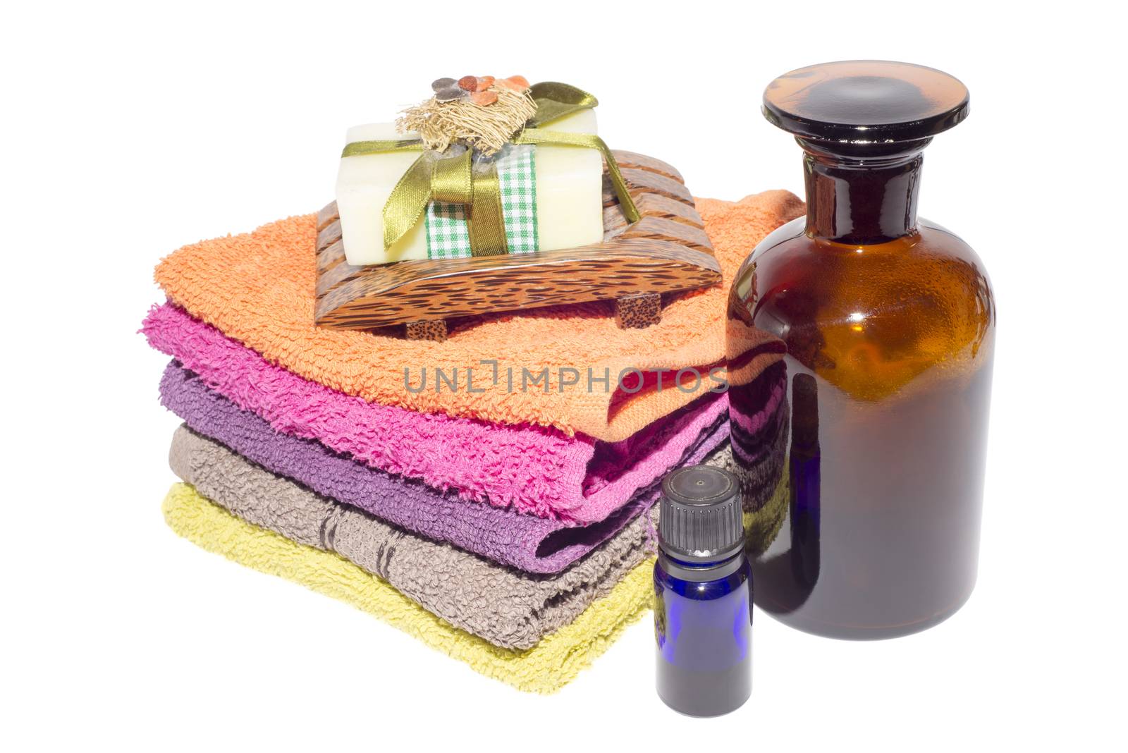 soap on top of facecloths of various shades with bottles