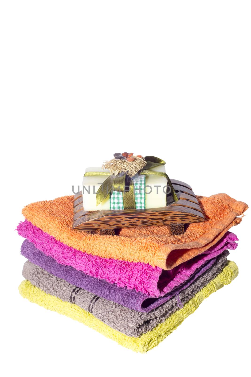 soap and dish on top of facecloths of various shades