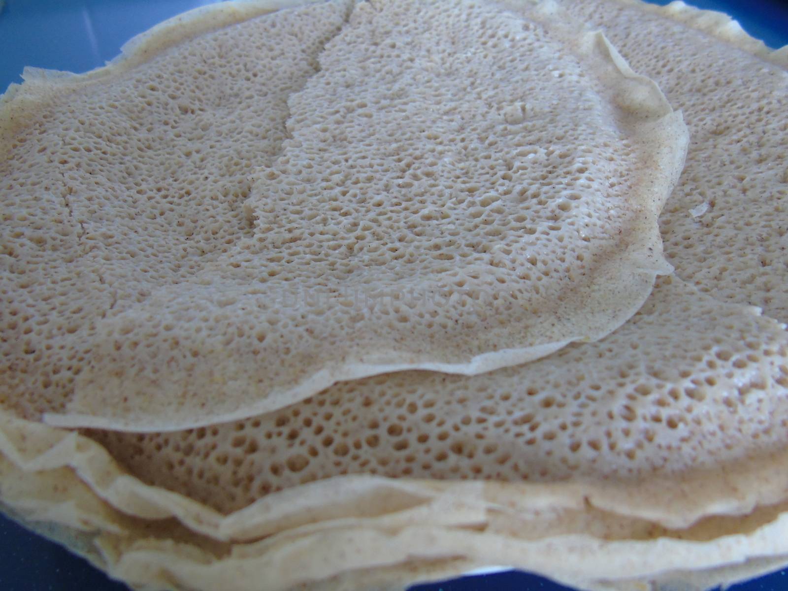 Asmara, Eritrea - 08/05/2020: Ethiopian and Eritrean food, assortment of main dishes. Injera is a sourdough flatbread made from teff flour. It is the national dish of Ethiopia, Eritrea.