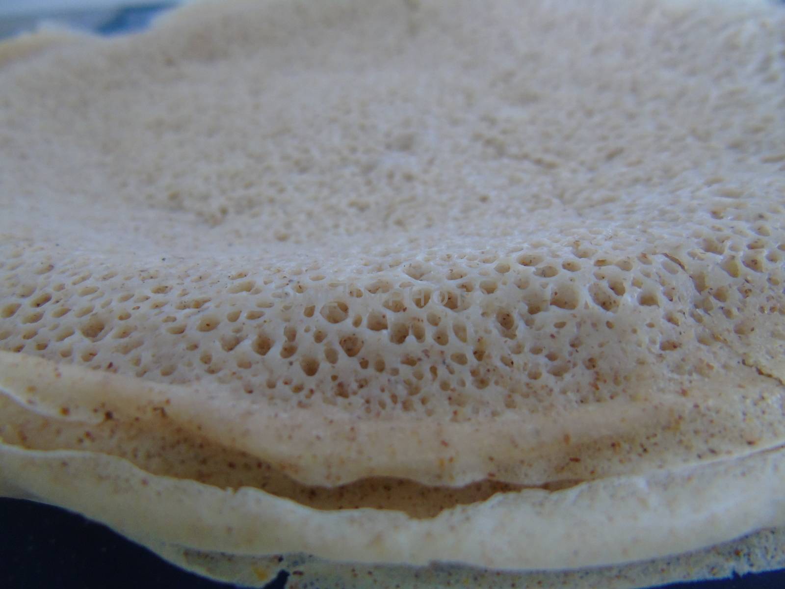 Asmara, Eritrea - 08/05/2020: Ethiopian and Eritrean food, assortment of main dishes. Injera is a sourdough flatbread made from teff flour. It is the national dish of Ethiopia, Eritrea.