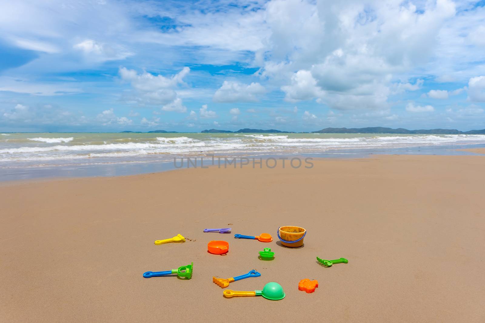Many colorful sand toy on the white sand beach at summer time.