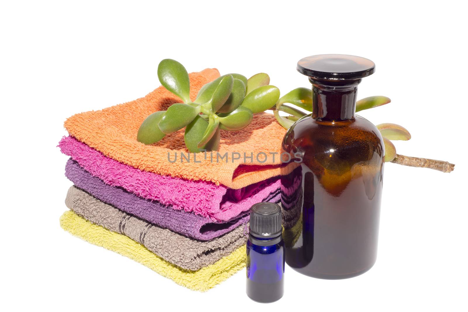 soap on top of facecloths of various shades with bottles