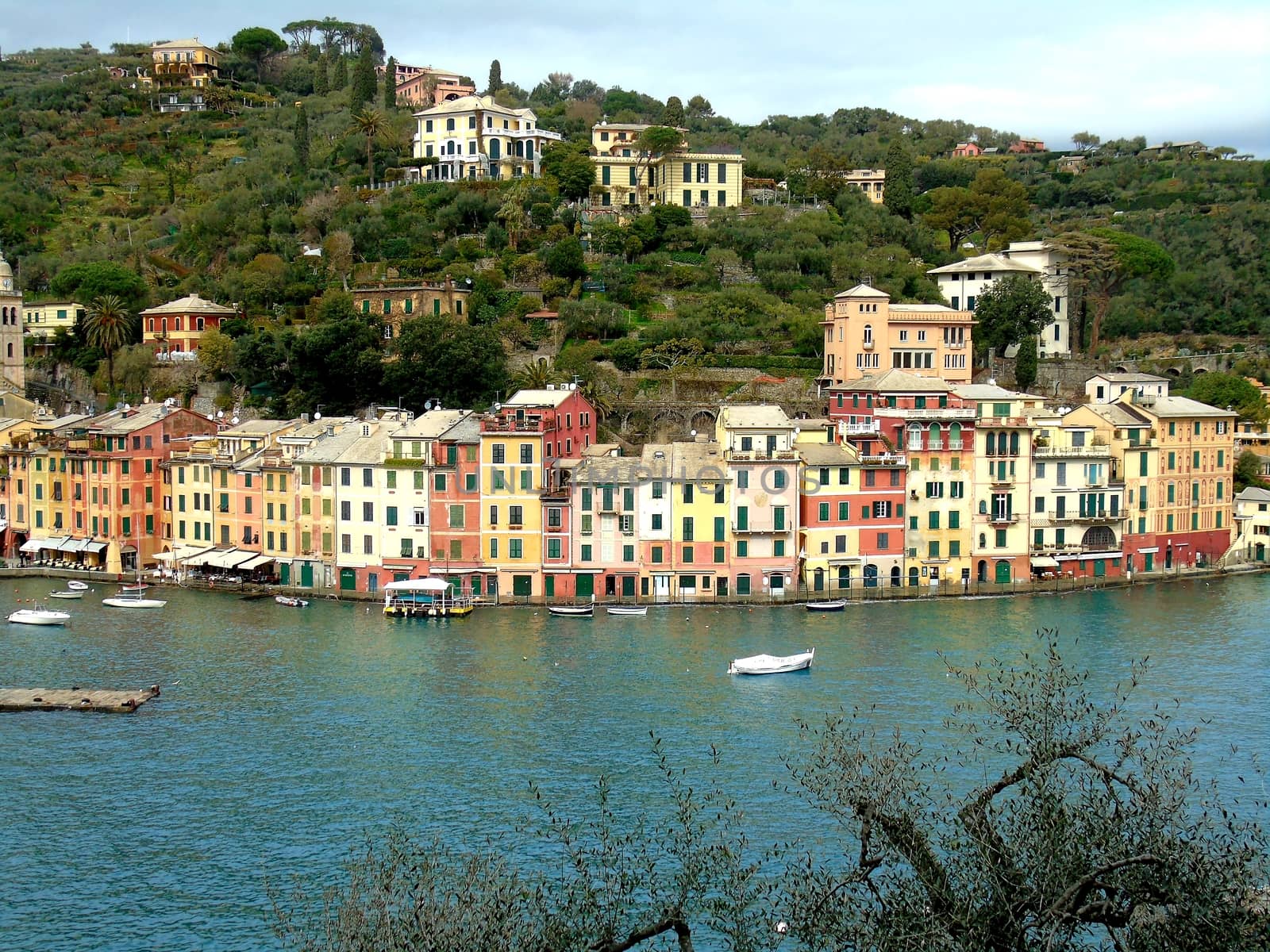 Liguria, Italy - 06/15/2020: Travelling around the ligurian seaside. Panoramic view to the seaside and the old villages. An amazing caption of the medieval coloured houses with grey sky in the background.