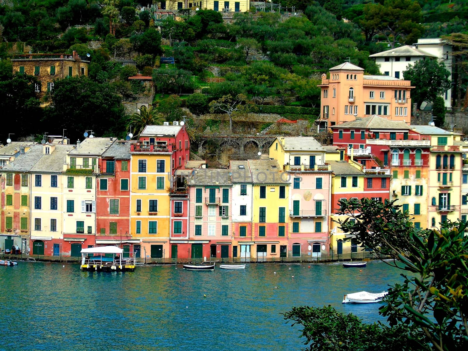 Liguria, Italy - 06/15/2020: Travelling around the ligurian seaside. Panoramic view to the seaside and the old villages. An amazing caption of the medieval coloured houses with grey sky in the background.