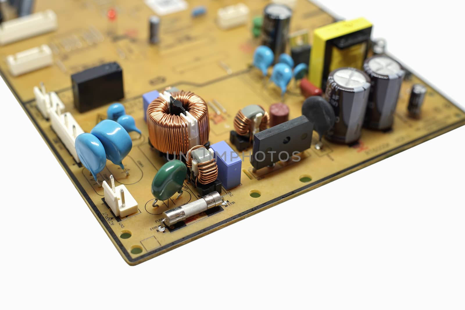 Closed up shot capacitor, coil, IC and Electronics parts on circuit board.