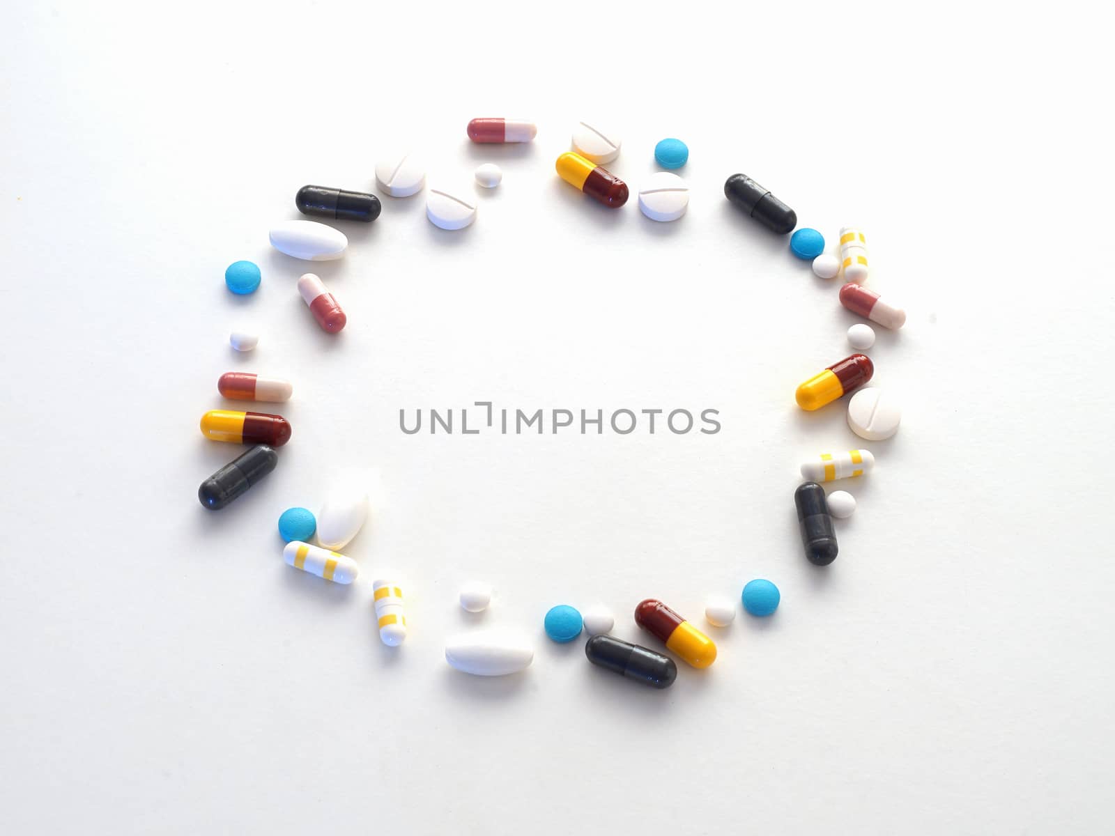 A lot of Pills arrange as circle on white background. by Desatit