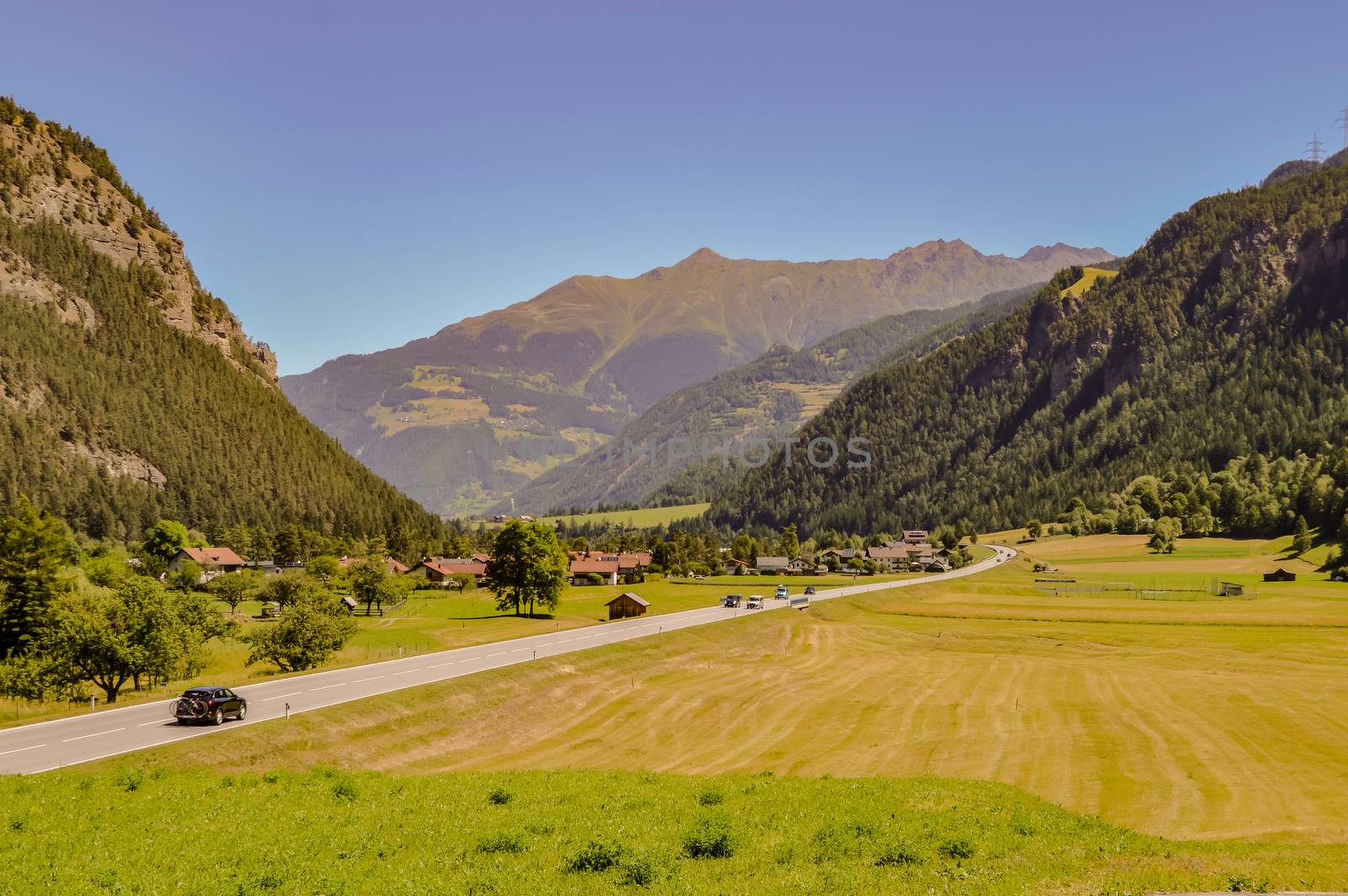 Austrian countryside and mountains under the sun