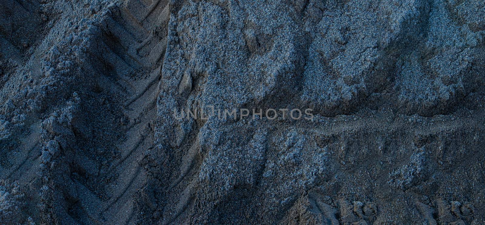 grey sand shot from above with tire marks by PeterHofstetter